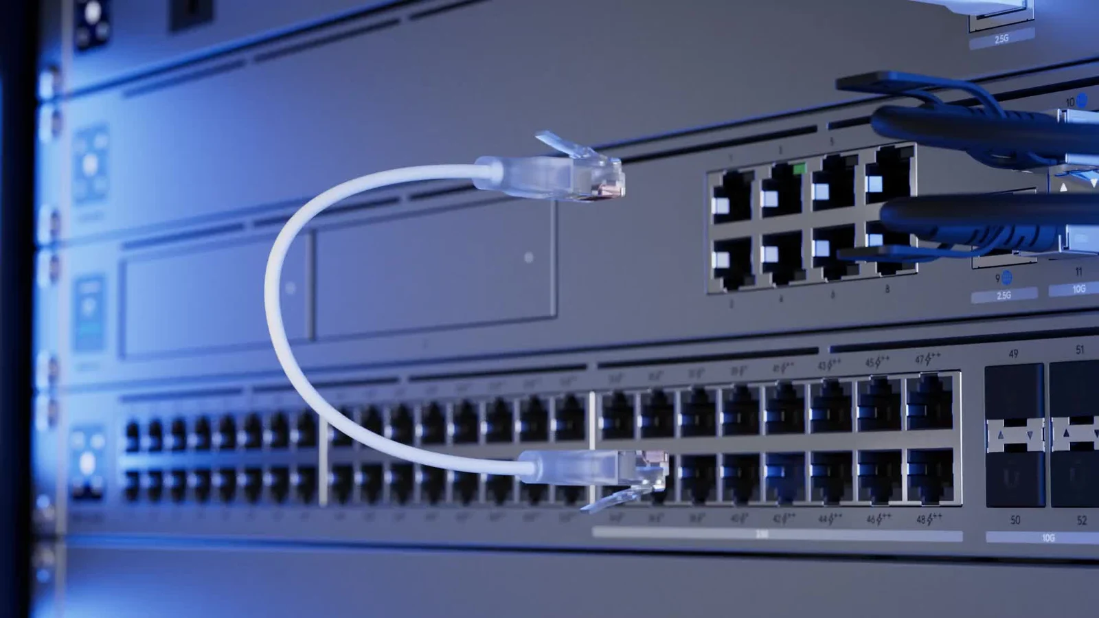 UniFi rack-mounted gateway and switches connected with Ethernet patch cables.