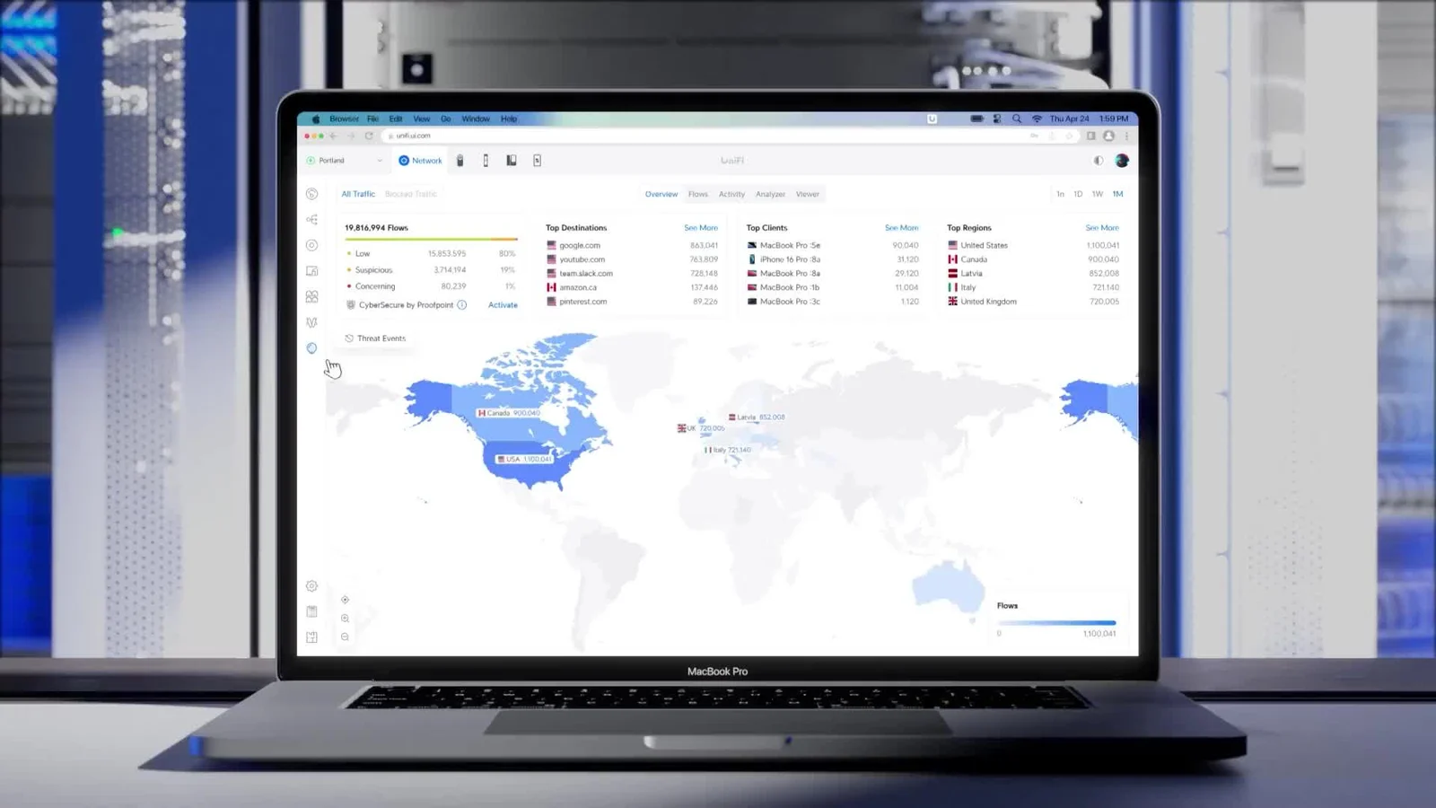 UniFi management interface displayed on a laptop in front of network equipment.