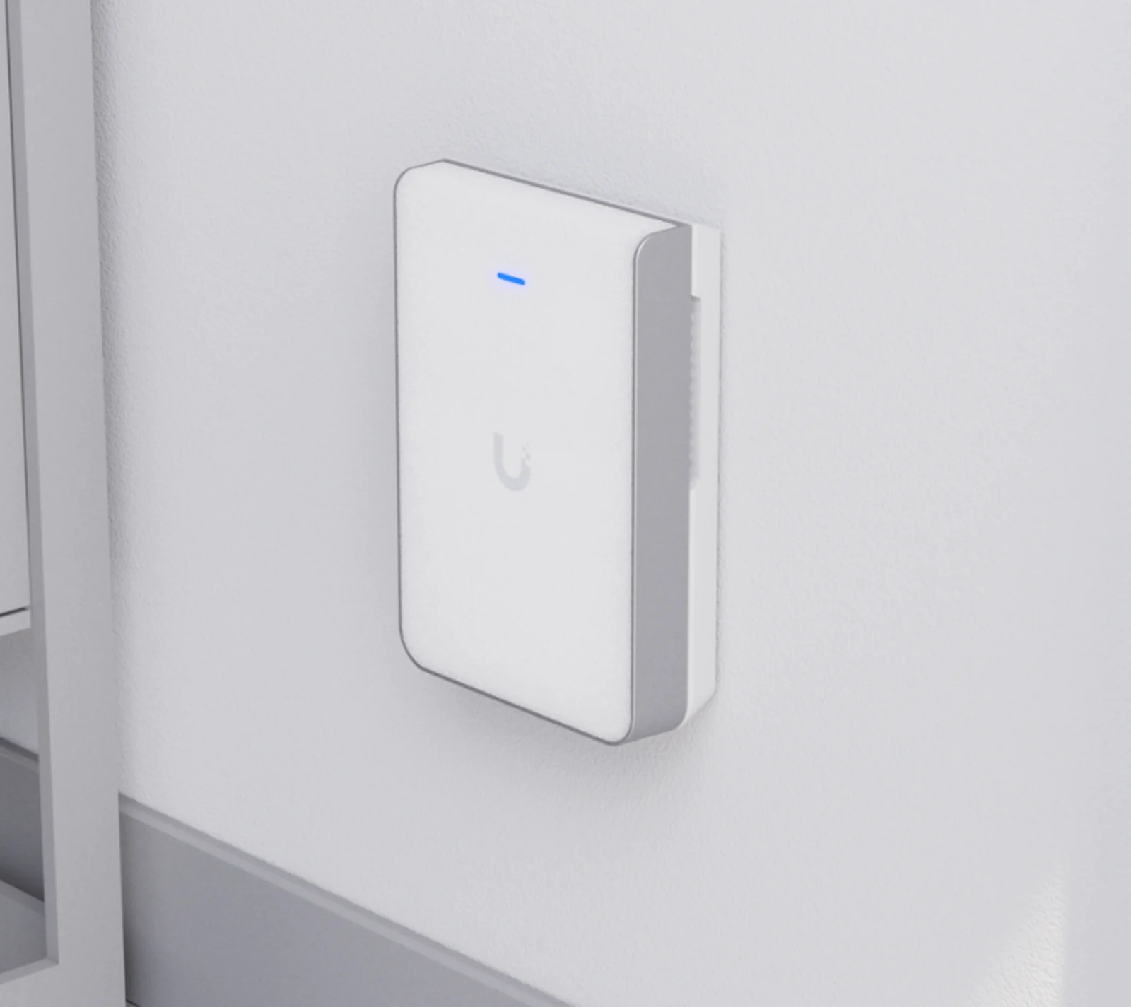 UniFi U7 Pro Wall access point installed on an interior wall.